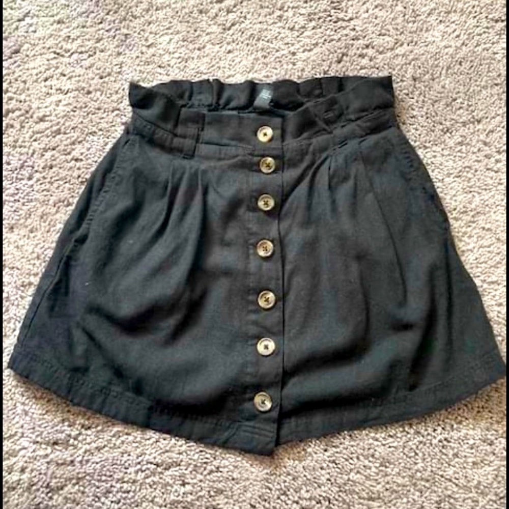 High waisted small black button up skirt